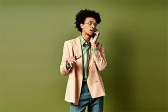 A man in a suit engaged in a conversation on his cell phone, exuding professionalism and focus.