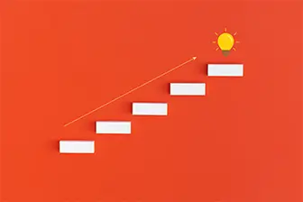 A minimalist graphic shows a series of white rectangular steps ascending diagonally on an orange background