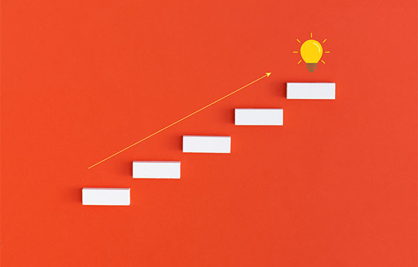 A minimalist graphic shows a series of white rectangular steps ascending diagonally on an orange background